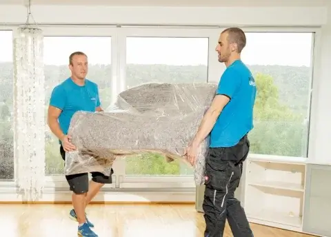 2 Möbelpacker tragen Sofa